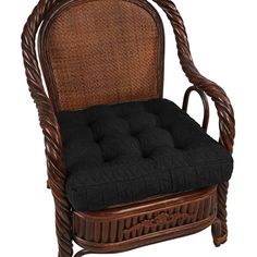 a wicker chair with black cushions on it's back and seat cushion in the middle