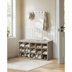 a shoe rack with shoes on it in front of a door and a rug underneath