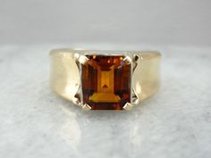 This fantastic ring is straight from the mid-1900's, and though designed for a man, it makes a great cocktail ring for the right lady! We've set this piece with a new, warm and glowing citrine in a bezel of reflective white gold. Handsome and sleek, this autumn hued ring would make a great gift for any occasion. Metal: 14K Yellow Gold and White Gold Gem: Citrine 2.16 Carats Gem Measurements: 7.2 x 8.9 mm, Rectangle Emerald Cut Ring Size: 7 Marks: "<14KT>" Stamped on the inside band Brown Polished Finish Signet Ring For Formal Occasions, Formal Brown Signet Ring With Polished Finish, Classic Brown Signet Ring For Anniversary, Timeless Citrine Rings For Formal Occasions, Elegant Citrine Signet Ring For Formal Occasions, Elegant Brown Gemstone Signet Ring, Elegant Formal Citrine Signet Ring, Elegant Brown Signet Ring For Formal Occasion, Elegant Brown Signet Ring For Anniversary