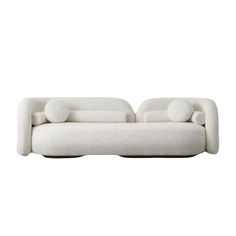 a white couch with two pillows on it