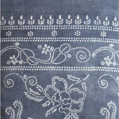 an old blue rug with white designs on it