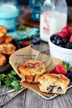 some muffins and berries on a table