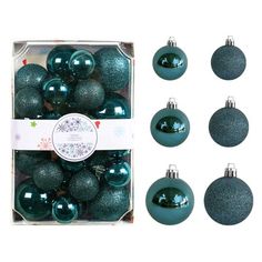 blue and green ornaments in a box on a white background