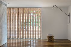 a room with wooden flooring and a wall made out of woven material on the walls