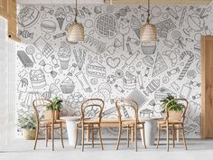 a dining room with chairs and a wall painted with doodles on the walls