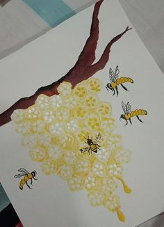 the bees are flying around the honeycombs on the tree branch, which is painted yellow and white