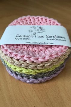 crochet washcloths are stacked on top of each other in different colors