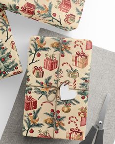 wrapping paper with christmas decorations on it next to scissors and other holiday gift wrappers