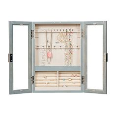 an open jewelry cabinet filled with necklaces and bracelets