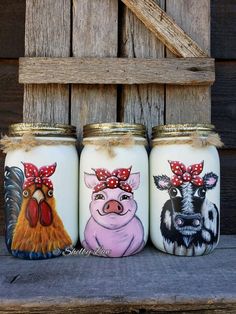 three painted jars with farm animals on them