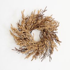 a dried flower wreath on a white background