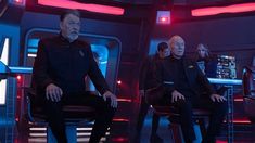 the crew of star trek sitting in chairs with their backs turned to look like they are talking