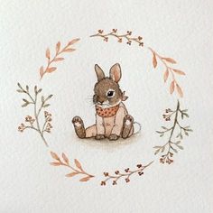 a watercolor drawing of a rabbit in a wreath