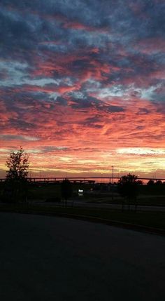 the sun is setting over an empty field