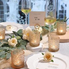 the table is set with candles and flowers