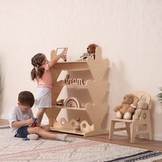 two children are playing with toys on the floor