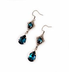 These dainty and elegantly ornate earrings are made with antique silver plated centerpieces, and silver tone settings, worn with stainless steel earring hooks. They are accented with dazzling dark aqua/teal glass crystals/jewels. Earrings measure 2 1/8" in length (including earring hooks) and 1/2" wide. More colors are available in our shop, along with matching chokers.If you don't see items with a color you want, feel free to ask about availability. Teal Crystals, Ornate Earrings, Medieval Steampunk, Gothic Antique, Ornate Necklace, Teal Jewelry, Dark Aqua, Teal Glass, Teal Earrings