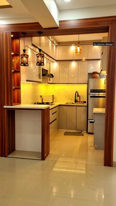 an empty kitchen with lights on the ceiling