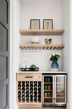 a kitchen with open shelving and wine bottles