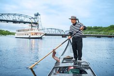 a man on a boat in the water with a paddle