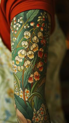 a woman's arm with flowers and leaves painted on the back of her leg