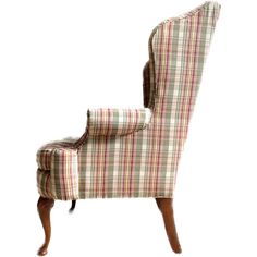 an upholstered wing chair with plaid fabric