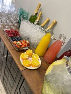 a table topped with lots of different types of fruit and drinks on top of it