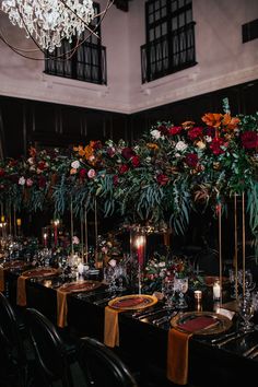 an image of a table setting with candles and flowers on it for a wedding reception