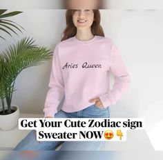 a woman wearing a pink sweater that says, get your cute zodiac sign sweater now