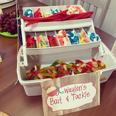 there are many different types of candies in the bins on the table with name tags