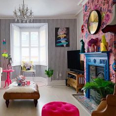 a living room filled with furniture and colorful wallpaper