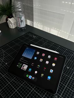 a tablet sitting on top of a black table