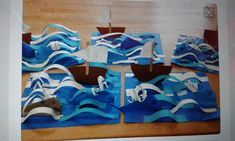 several pieces of art made to look like boats in the water with sails on them