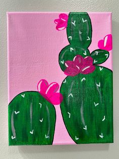 a painting of two green cactuses with pink bows on it's heads, against a white wall