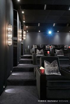 an empty movie theater with black seats