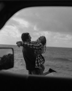 a man carrying a woman on his back by the ocean