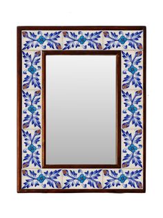 a mirror with blue and white designs on it's sides, in front of a white background