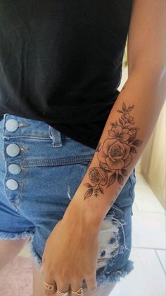 a woman with a flower tattoo on her arm