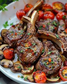 steak with mushrooms and cherry tomatoes on a white platter, ready to be eaten