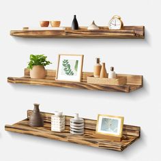 three wooden shelves with pictures and vases on them