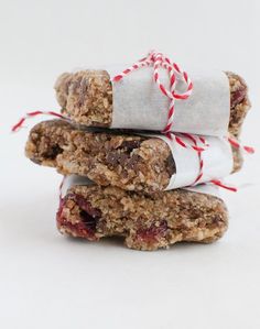 three granola bars stacked on top of each other with red and white twine