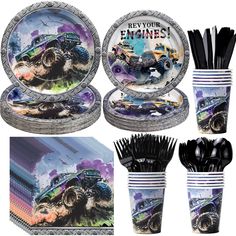 a set of plates, cups and utensils with monster trucks on them