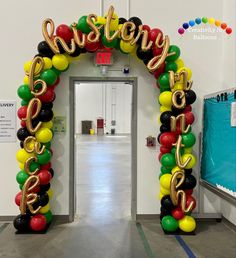 the entrance to an office decorated with balloons