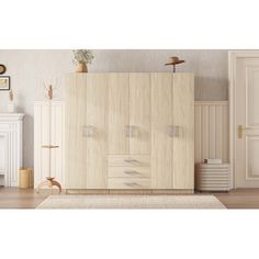 a living room with white furniture and wood floors, including a dresser cabinet in the middle