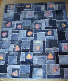 a blue patchwork rug with hearts on it