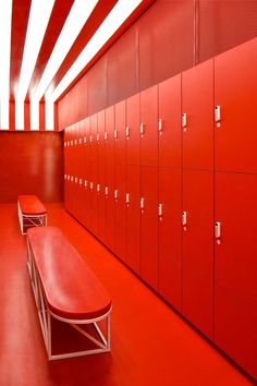 the lockers are lined up against the red wall