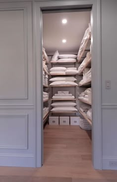 an open closet filled with lots of white items