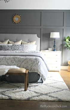 a bedroom with gray walls and white carpeted flooring is pictured in this image