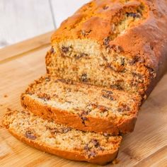 a loaf of banana bread sitting on top of a wooden cutting board