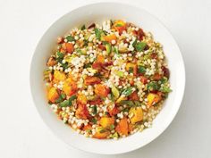 a white bowl filled with rice and vegetables